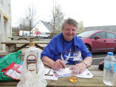 Writing postcards while waiting to book into Hotel at Bayeux
